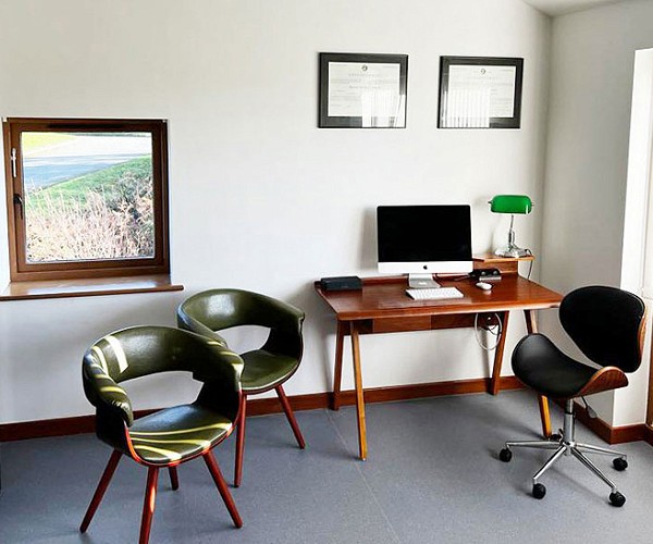 Office with desk, chairs and a small window