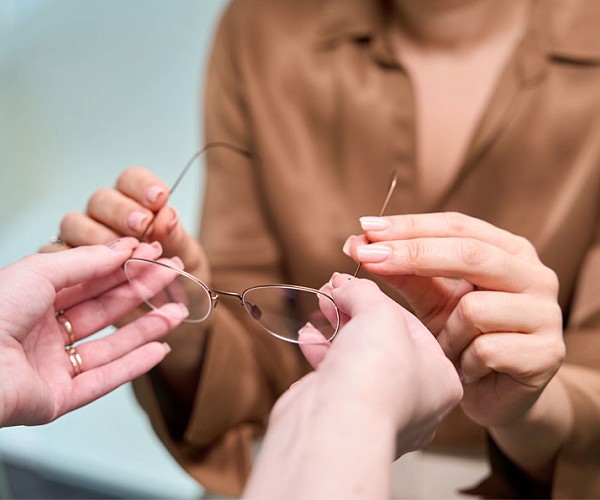 clos up of somebody passing glasses over to a patient