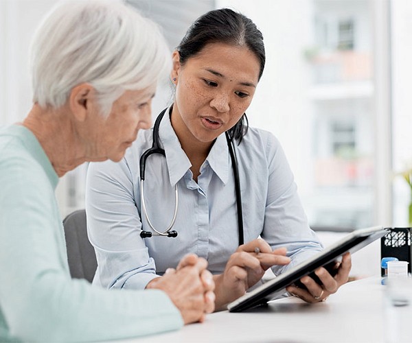 Doctor consulting with elderly patient